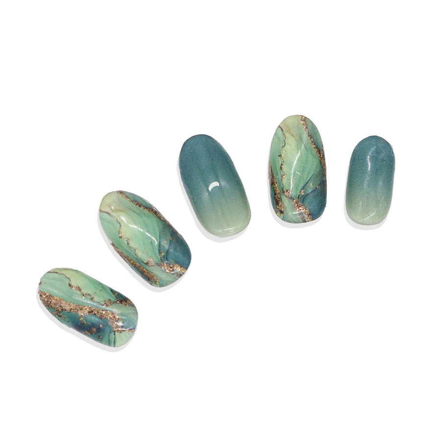 Five green stone-pattern nail stickers shown on false nail tips against a white background.