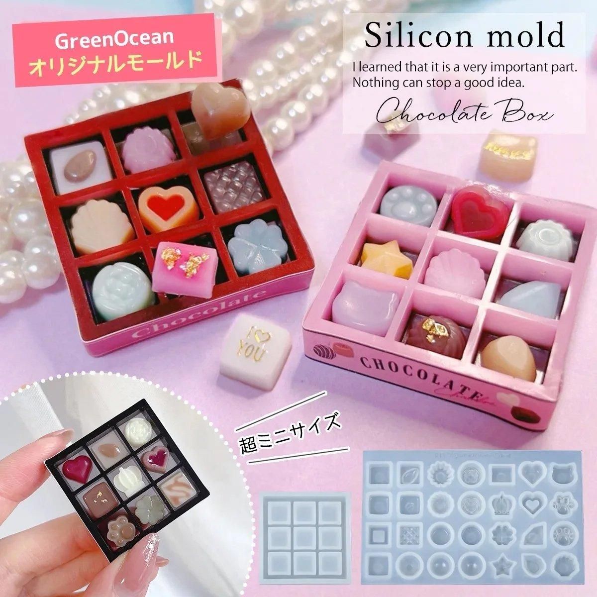 Silicone chocolate-box mold shown with sample miniature chocolate pieces displayed in small boxes.