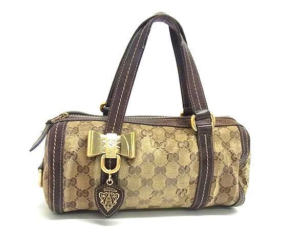 Brown Gucci GG-pattern coated canvas and leather mini bow handbag shown on a white background.