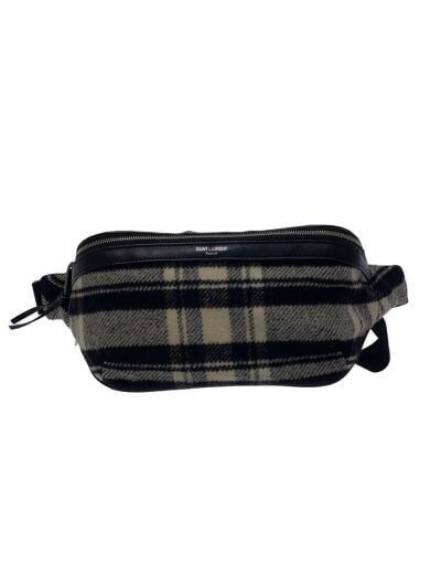 Front view of a black and beige checked wool waist bag with a top zipper and an adjustable strap.