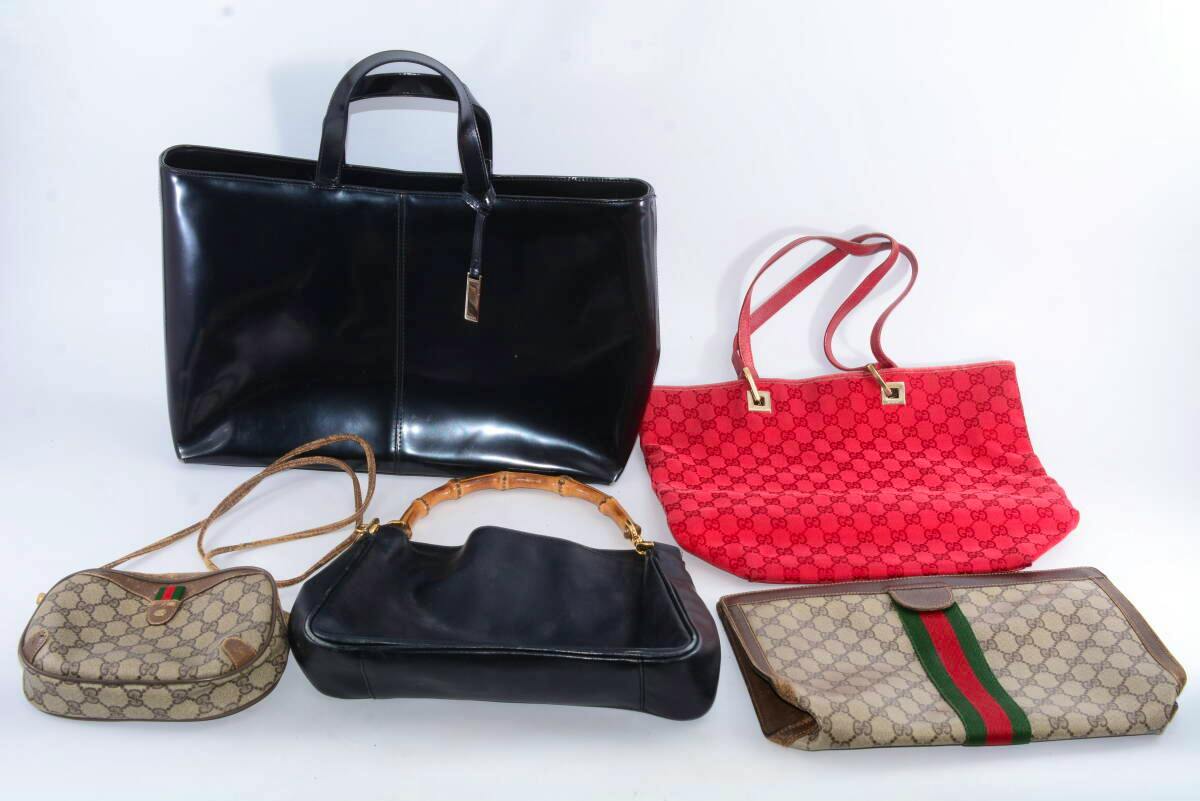 Five Gucci bags in various styles and colors arranged on a white background.