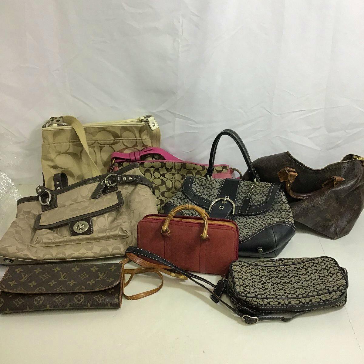 Assorted used wallets and handbags arranged on a white backdrop, shown together in a group.