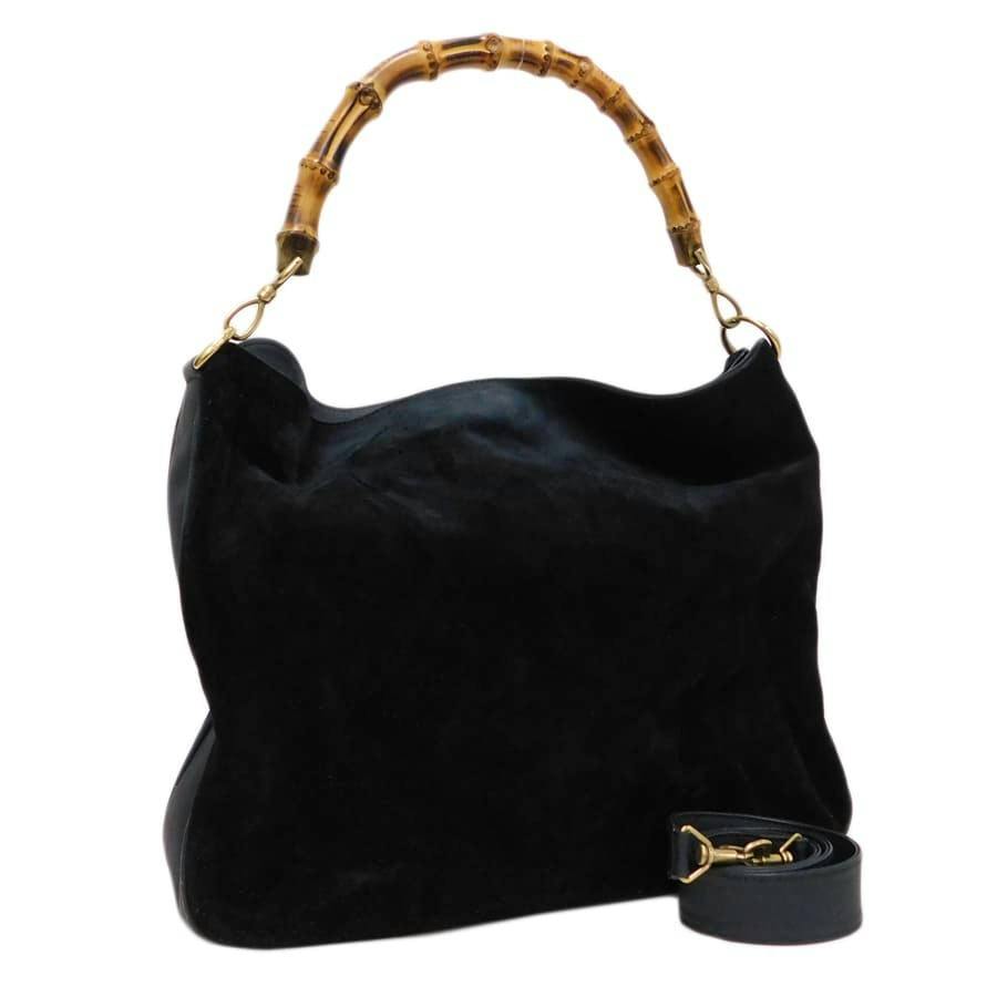 Gucci black suede 2-way bag with a bamboo top handle and a detachable shoulder strap.