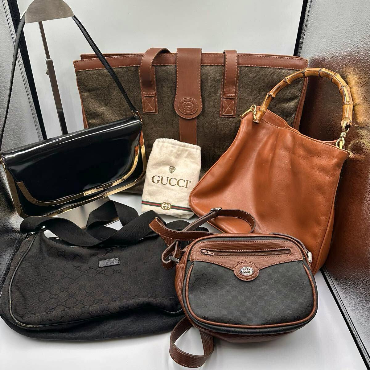 Five Gucci bags of varying styles arranged together with a Gucci dust bag.