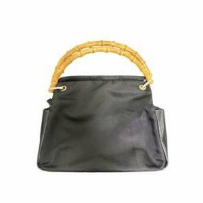 Front view of a black Gucci nylon handbag with a bamboo handle.