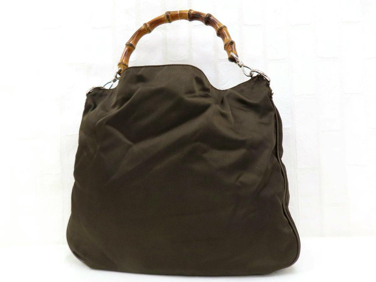 Brown Gucci nylon shoulder bag shown front-facing with a bamboo handle and silver hardware.