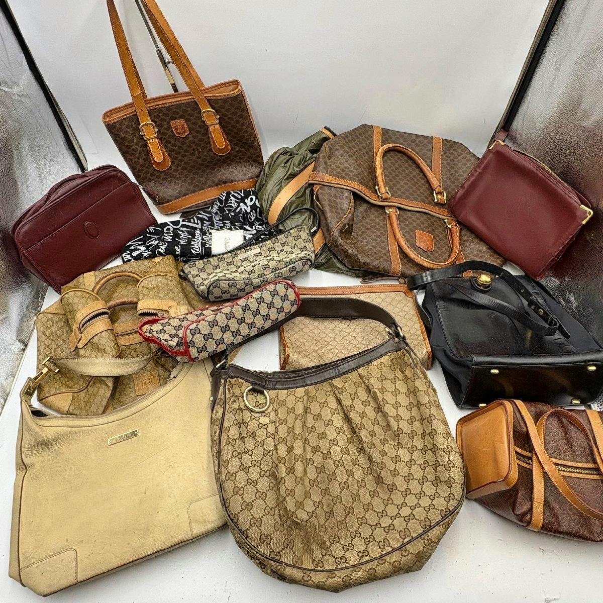 Several designer handbags and pouches arranged together showing a bulk set of bags.