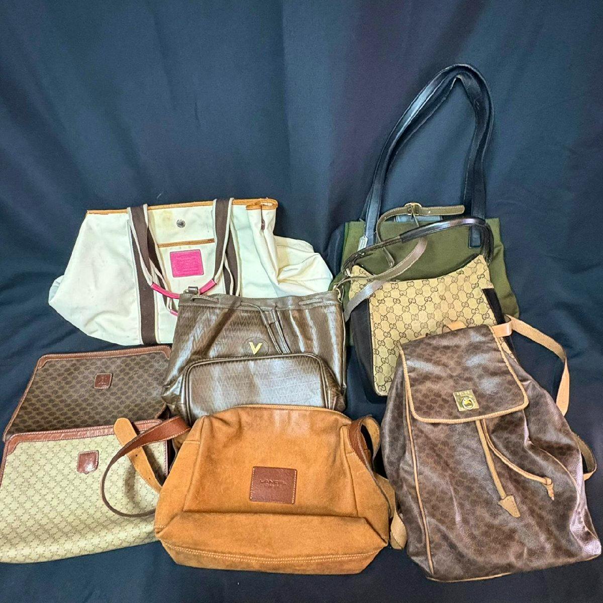 Several used bags arranged on a dark background showing various leather and canvas styles and straps.