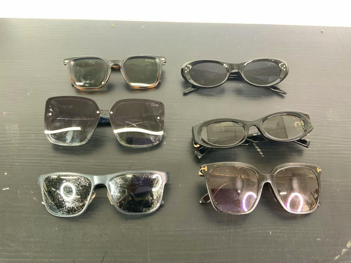 Six pairs of sunglasses arranged on a dark surface, shown as a set.