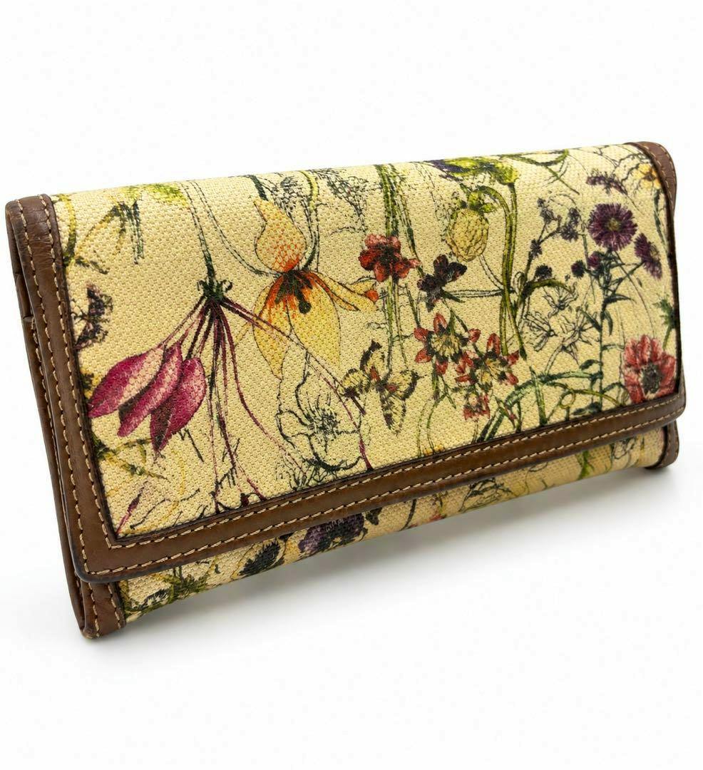 Front view of a GUCCI Flora floral canvas long wallet with brown leather trim.