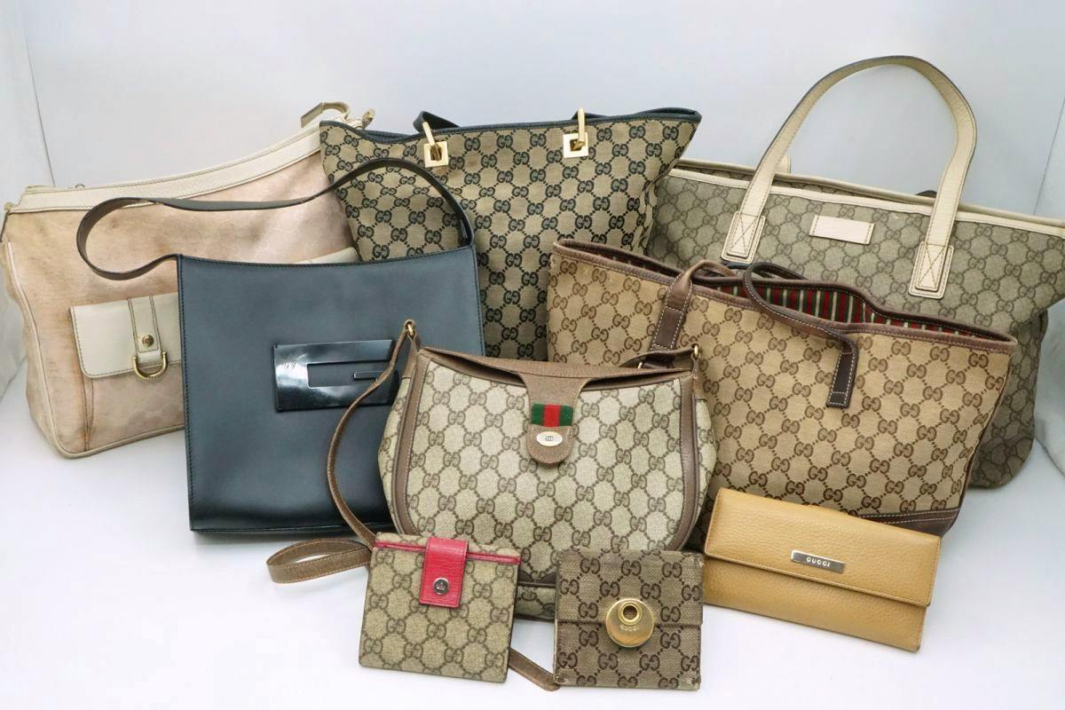 Several Gucci canvas handbags, totes, and wallets with GG monogram displayed on a white background.