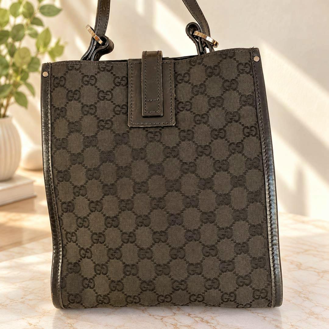 Front view of the black GUCCI GG canvas shoulder bag showing the monogram pattern and leather trim.