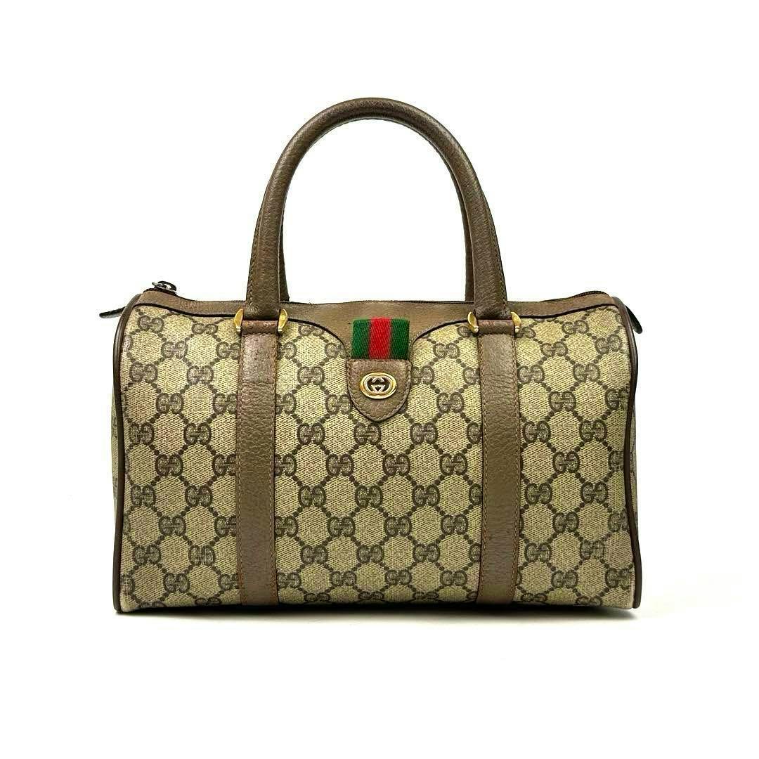 Front view of a brown Gucci GG Supreme mini Boston handbag with leather handles and a green-red-green web stripe.