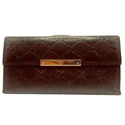 Front view of a dark brown GUCCI bi-fold long wallet in embossed leather with a gold logo plate.