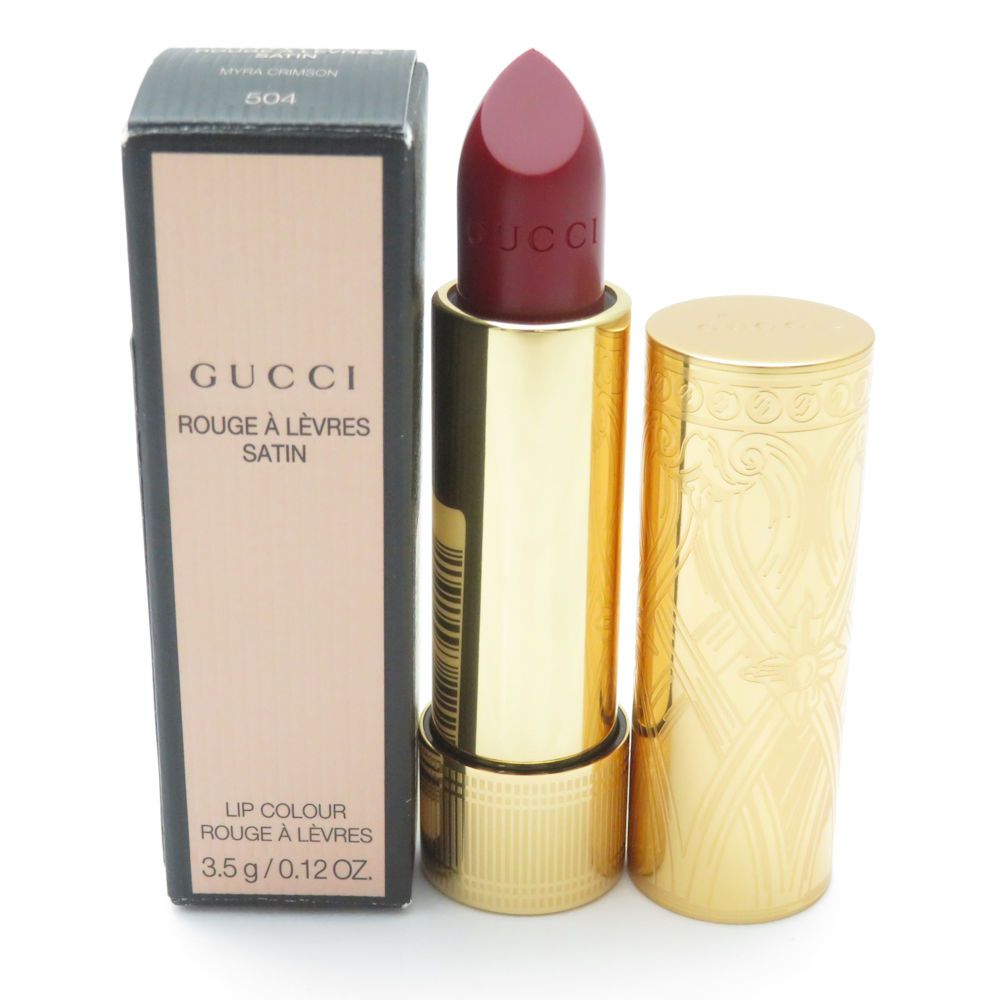 Gucci Rouge à Lèvres Satin lipstick (shade 504) in a gold tube displayed next to its box.