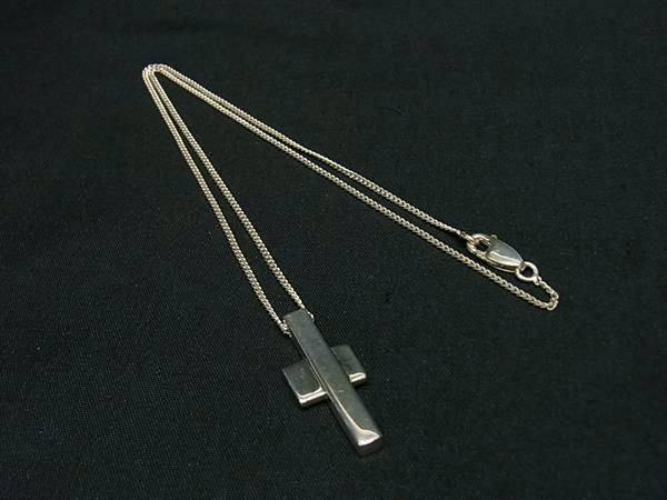 GUCCI SV925 silver cross pendant necklace laid flat on a black background.