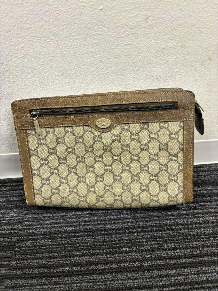Front view of the GUCCI vintage GG-pattern clutch/second bag showing a front zip pocket and brown leather trim.