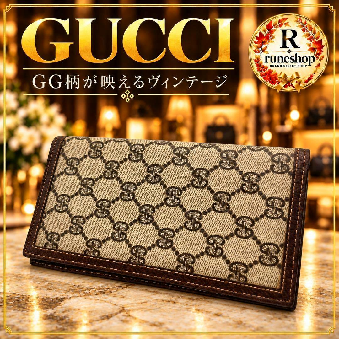 A Gucci vintage long wallet with GG monogram pattern shown on a marble surface.