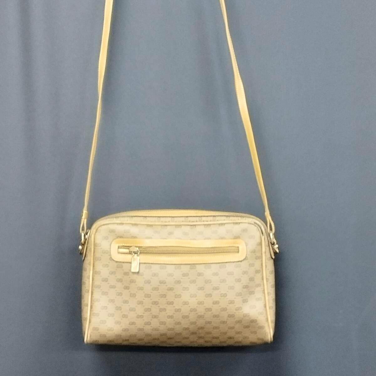 Front view of the Gucci micro GG canvas shoulder bag with a front zip pocket and long shoulder strap.