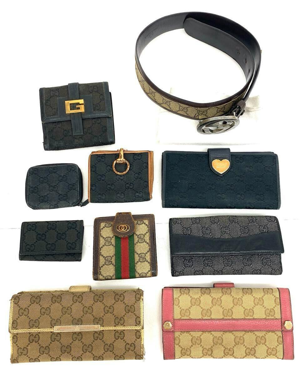 Multiple GUCCI wallets and a GG canvas belt arranged on a white background.
