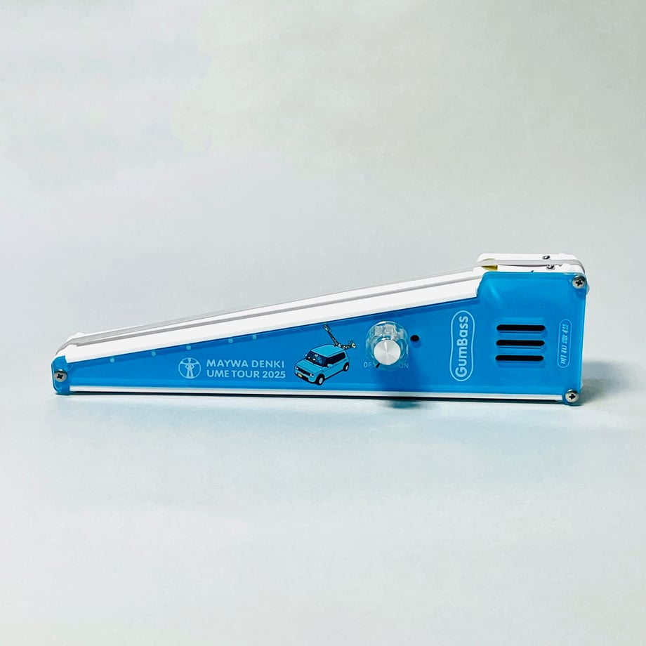 Side view of a blue Gumbass Pocket wedge-shaped speaker with a control knob and speaker grille on a white background.