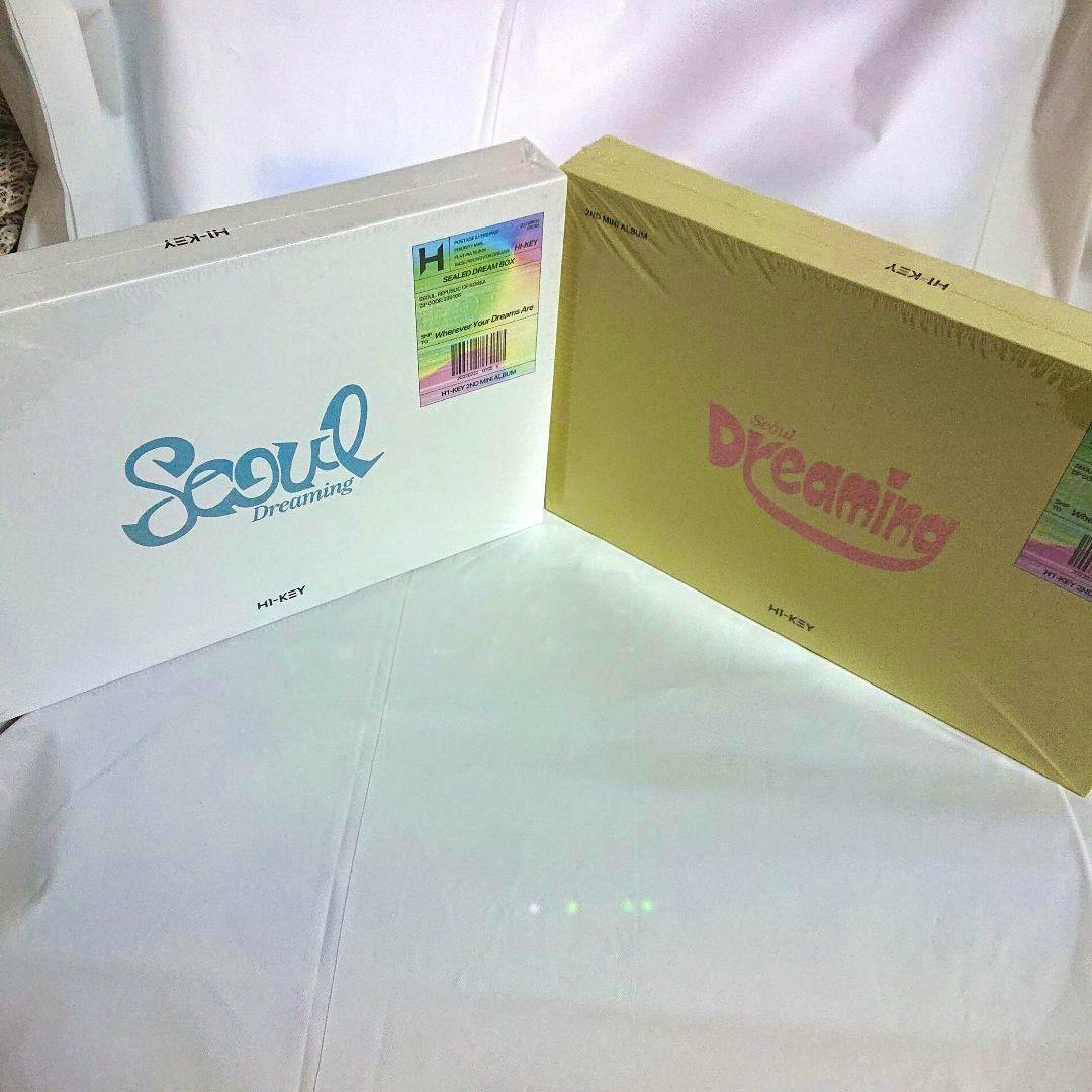 Two sealed H1-KEY "Seoul Dreaming" 2nd mini album boxes, one white and one yellow, on a white surface.