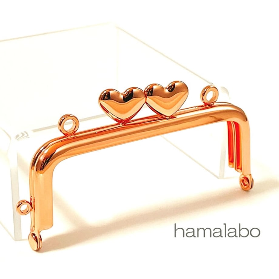 Rose-gold rectangular 8.5cm metal purse frame with two heart-shaped kiss-locks and attachment rings.