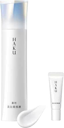 HAKU Melano Focus IV beauty serum full-size bottle, a mini HAKU tube, and a small smear of the product on a white background.