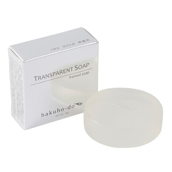 A round transparent body soap bar displayed beside its white product box.