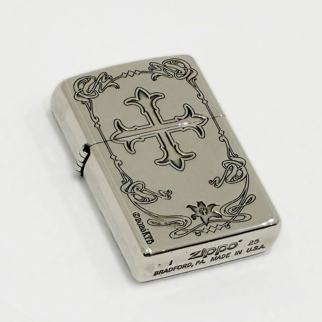 Silver Zippo case with an engraved cross and decorative border shown on a white background.