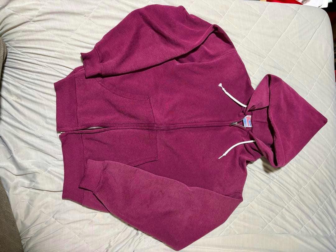 Magenta zip-up hoodie laid flat showing the front with zipper, kangaroo pockets, and hood.