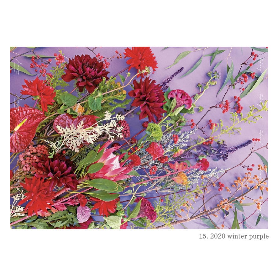 Purple wrapping paper printed with red and pink flowers and small gray text in the lower-right.