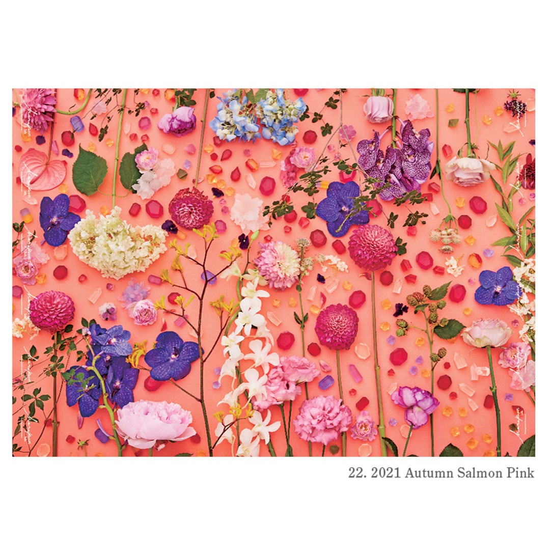A sheet of salmon-pink wrapping paper printed with assorted flowers and scattered petals with the text '22. 2021 Autumn Salmon Pink'.