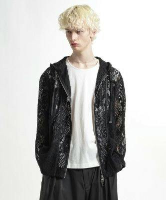 Model wearing a black flower-lace zip-up hoodie over a white T-shirt.