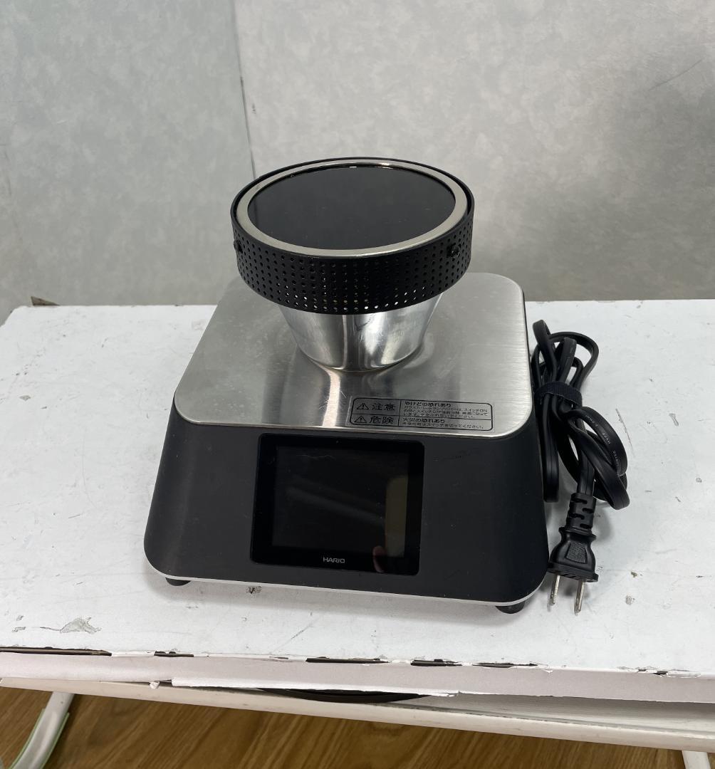 Front view of a HARIO coffee siphon beam heater (BGSTN-350J) on a white surface with its power cord.