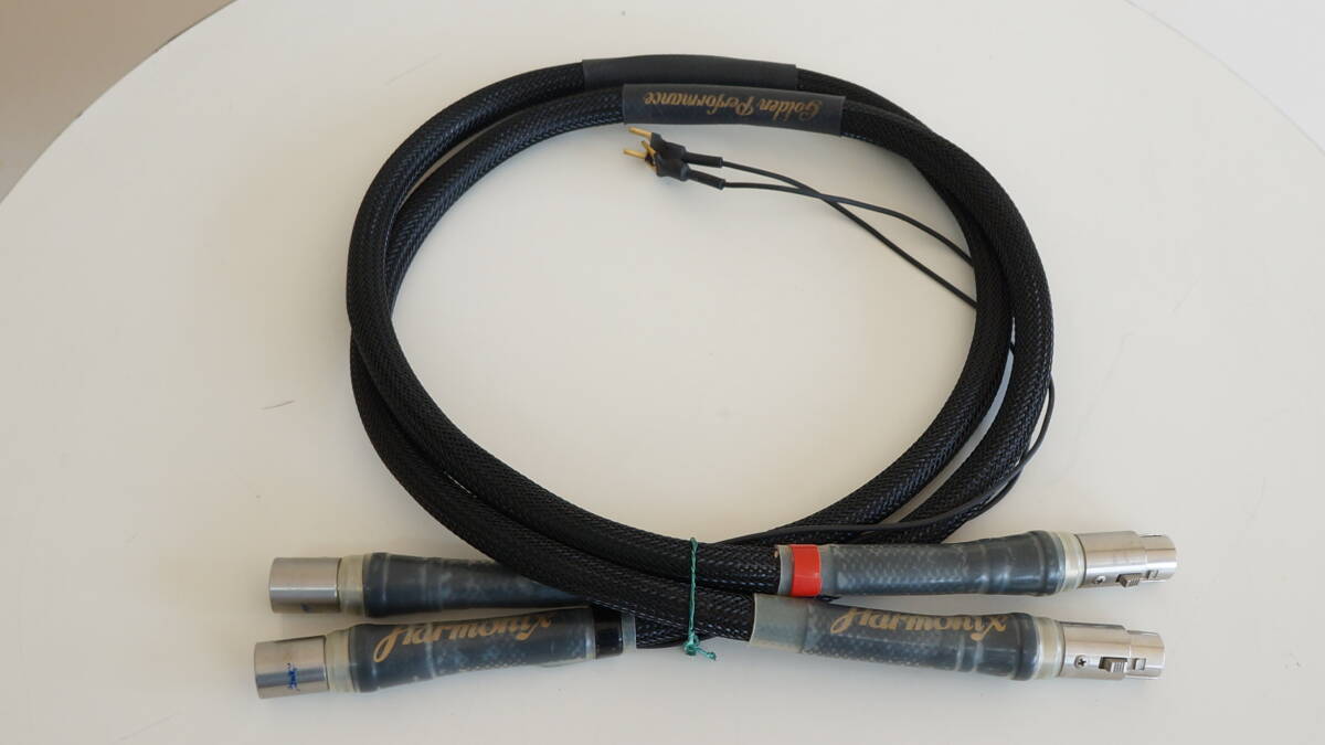 Two Harmonix Golden Performance HS-101GP-XLR XLR cables coiled on a white surface with visible XLR connectors and braided sleeves.