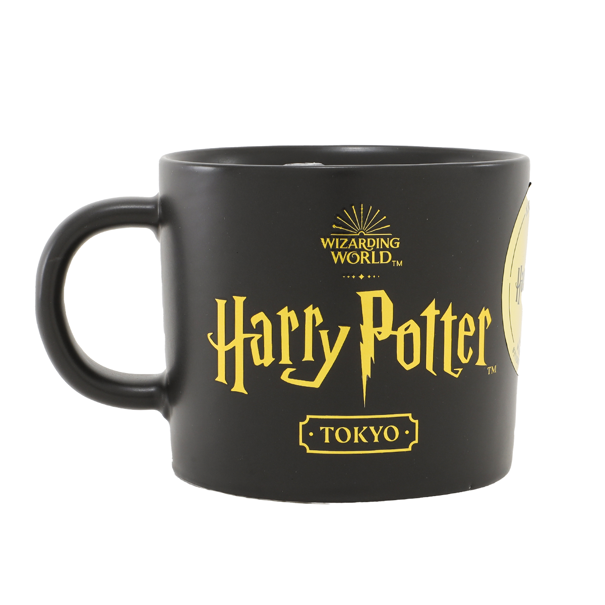 Black ceramic Harry Potter Tokyo mug with yellow logo and visible handle.