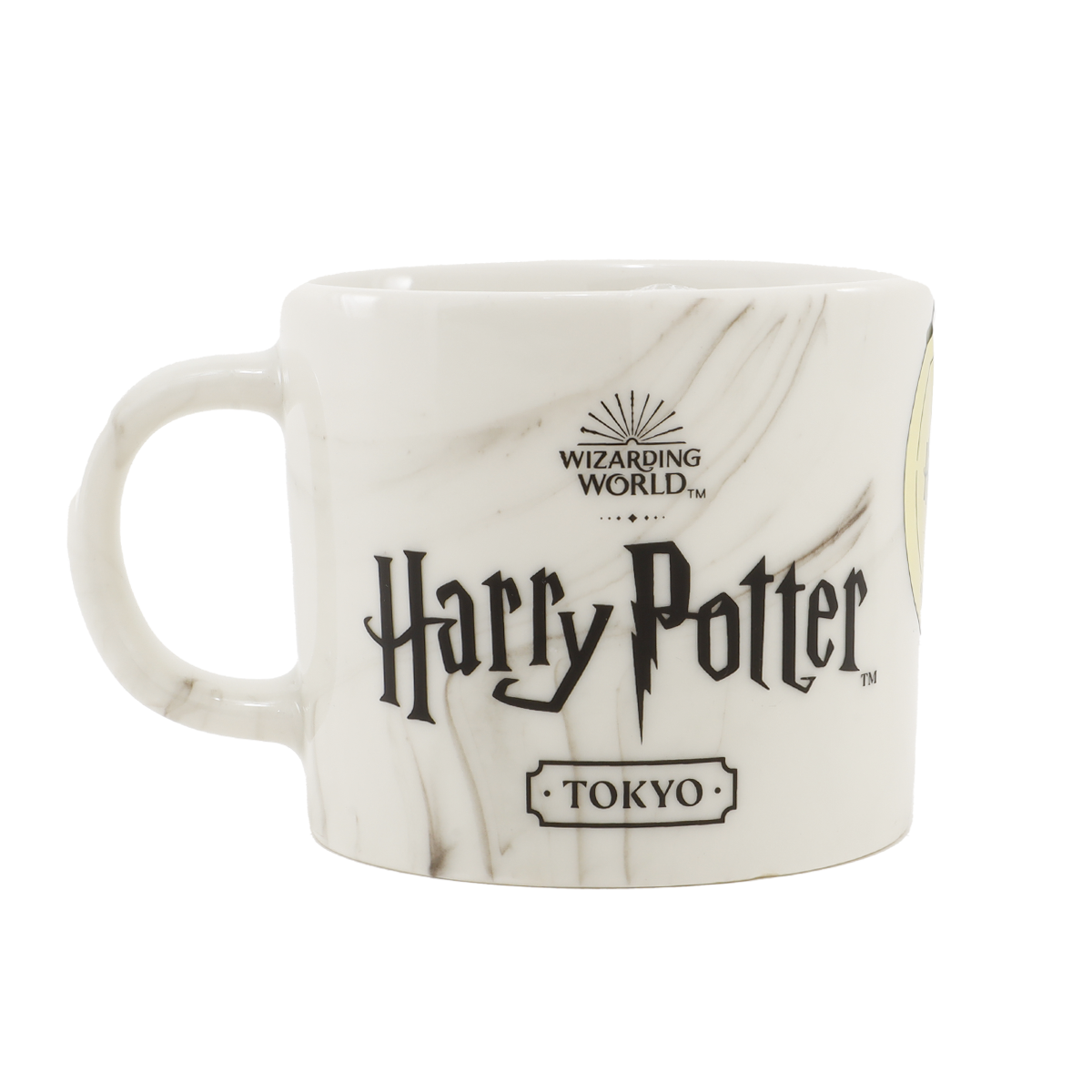 White ceramic Harry Potter mug with a Tokyo label and marble pattern on a black background.