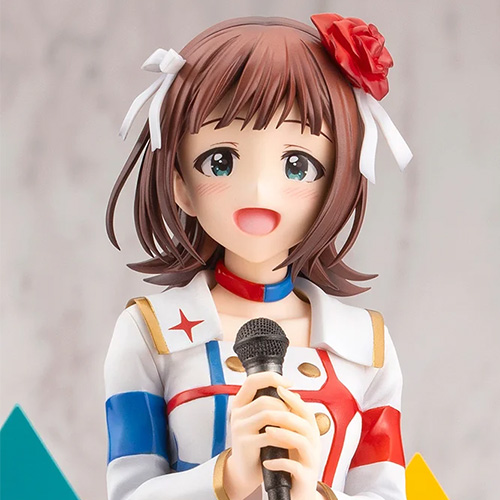 Close-up photo of the 天海春香-THE IDOLM＠STER 20th anniversary- plastic figure holding a microphone and smiling.