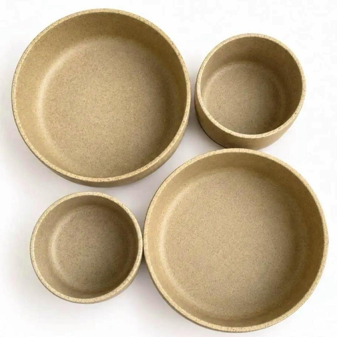 Top-down photo of four natural-colored HASAMI porcelain bowls showing their interiors.