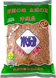 Front view of a packaged Hateruma black sugar powder bag showing brown granulated sugar inside and green packaging accents.