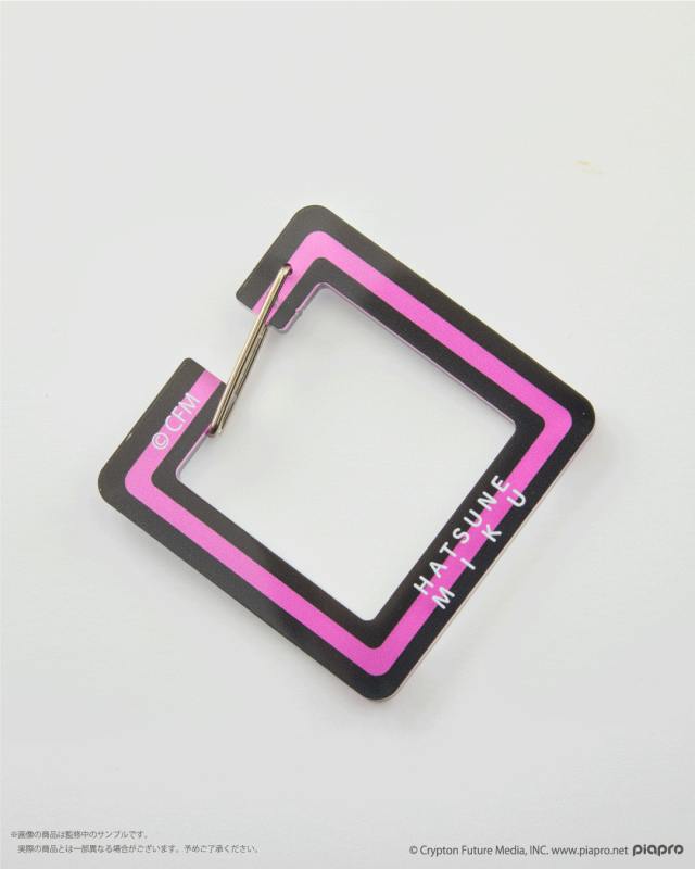 Square acrylic keychain carabiner with black and pink borders and a small metal clasp, labeled "HATSUNE MIKU".