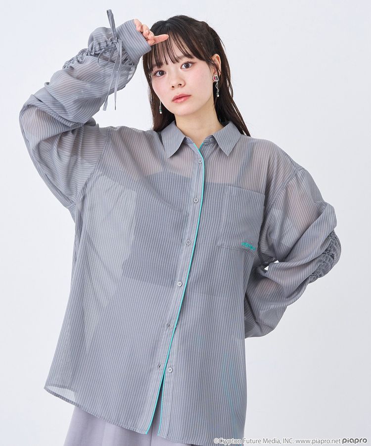 Model wearing the Hatsune Miku image sheer women's button-up shirt in translucent striped grey fabric.