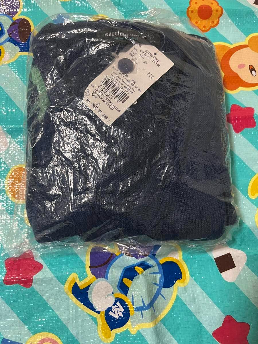 Folded Hatsune Miku cardigan in clear plastic packaging with a retail tag, placed on a colorful play mat.