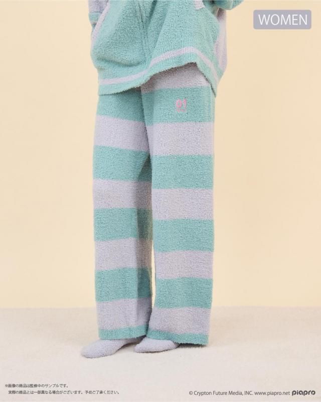 A model wearing the Hatsune Miku roomwear long pants with wide pastel green and lavender horizontal stripes.