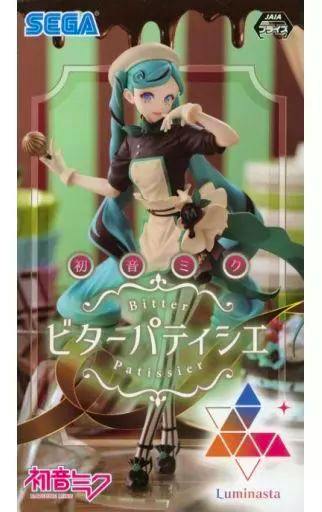 Front of the product box showing the Hatsune Miku "Luminasta Bitter Patissier" figure illustration with SEGA and Luminasta logos.