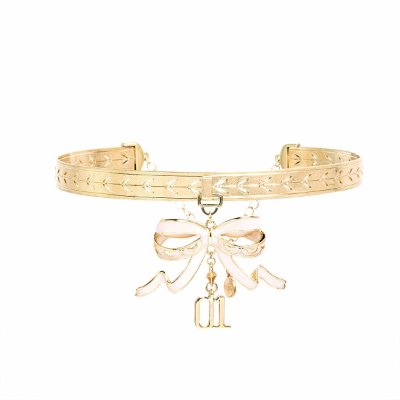 Gold-tone choker necklace with an engraved band and a dangling bow charm.