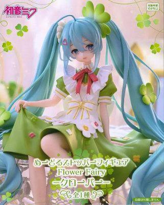 A seated Hatsune Miku noodle-stopper figure wearing a clover-themed green and white dress with long turquoise twin tails.
