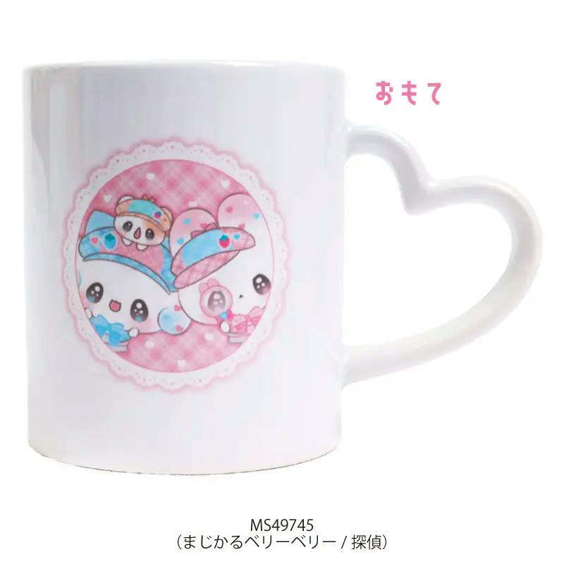 White ceramic cup with a pink circular character illustration and a heart-shaped handle.