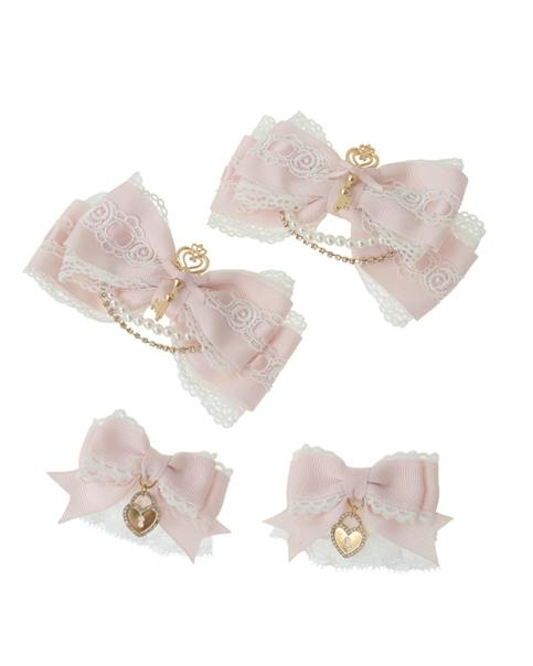 Four pink lace-trimmed hair ribbons with gold heart-lock charms (two large, two small) on a white background.